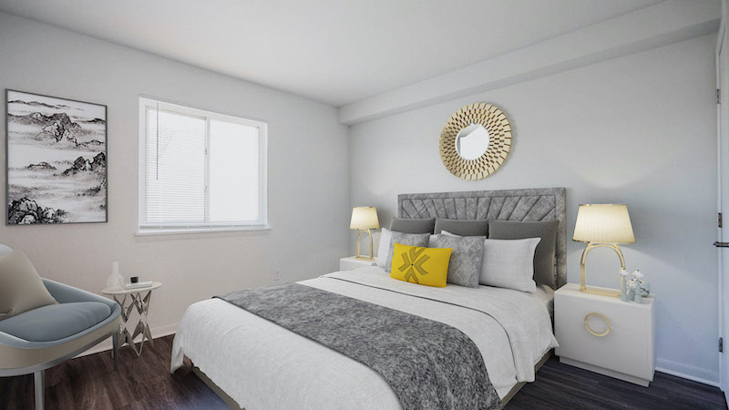 furnished bedroom with gray accents and a bright window