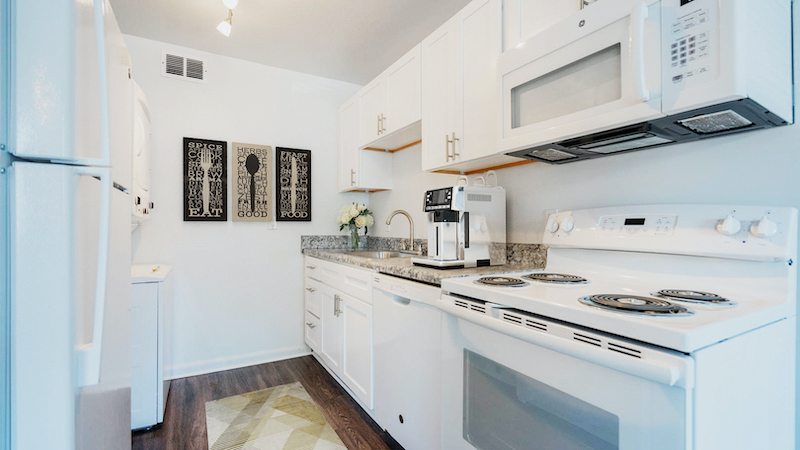 furnished kitchen with white appliances