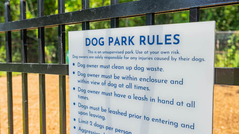 close up of dog park rules sign