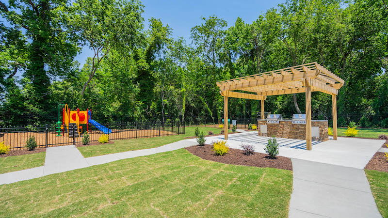 lush green outdoor area with grills and playground